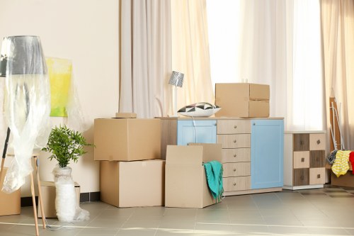 Furniture removal team handling sofas and boxes in Acton