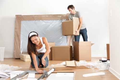 A local team organising office equipment and boxes during an Acton move