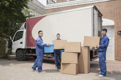 Moving van and trained movers handling items safely in Acton