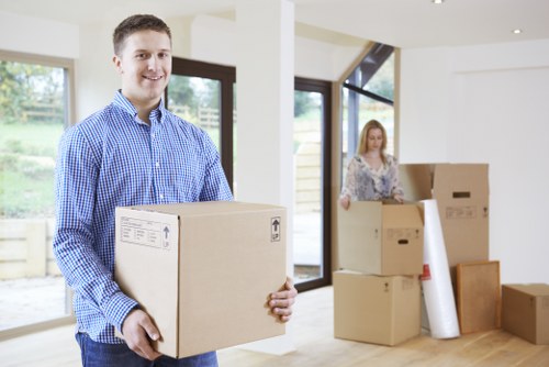 Professional movers handling furniture removal in a local Acton property