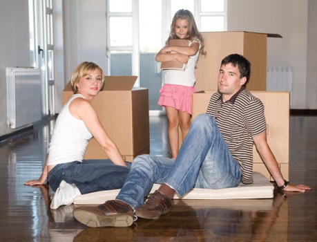 Removal team loading furniture for a house relocation in Acton